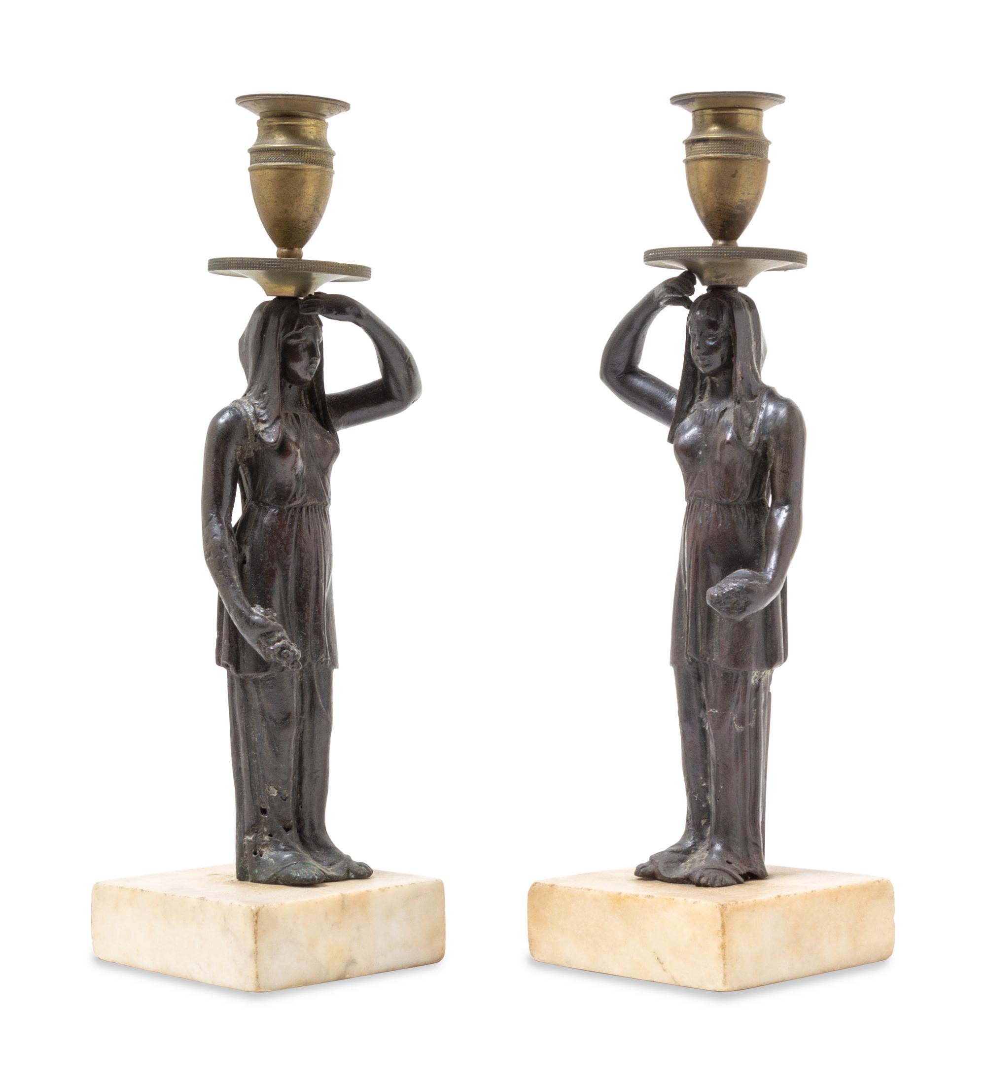 A Pair of Bronze Figural Candlesticks