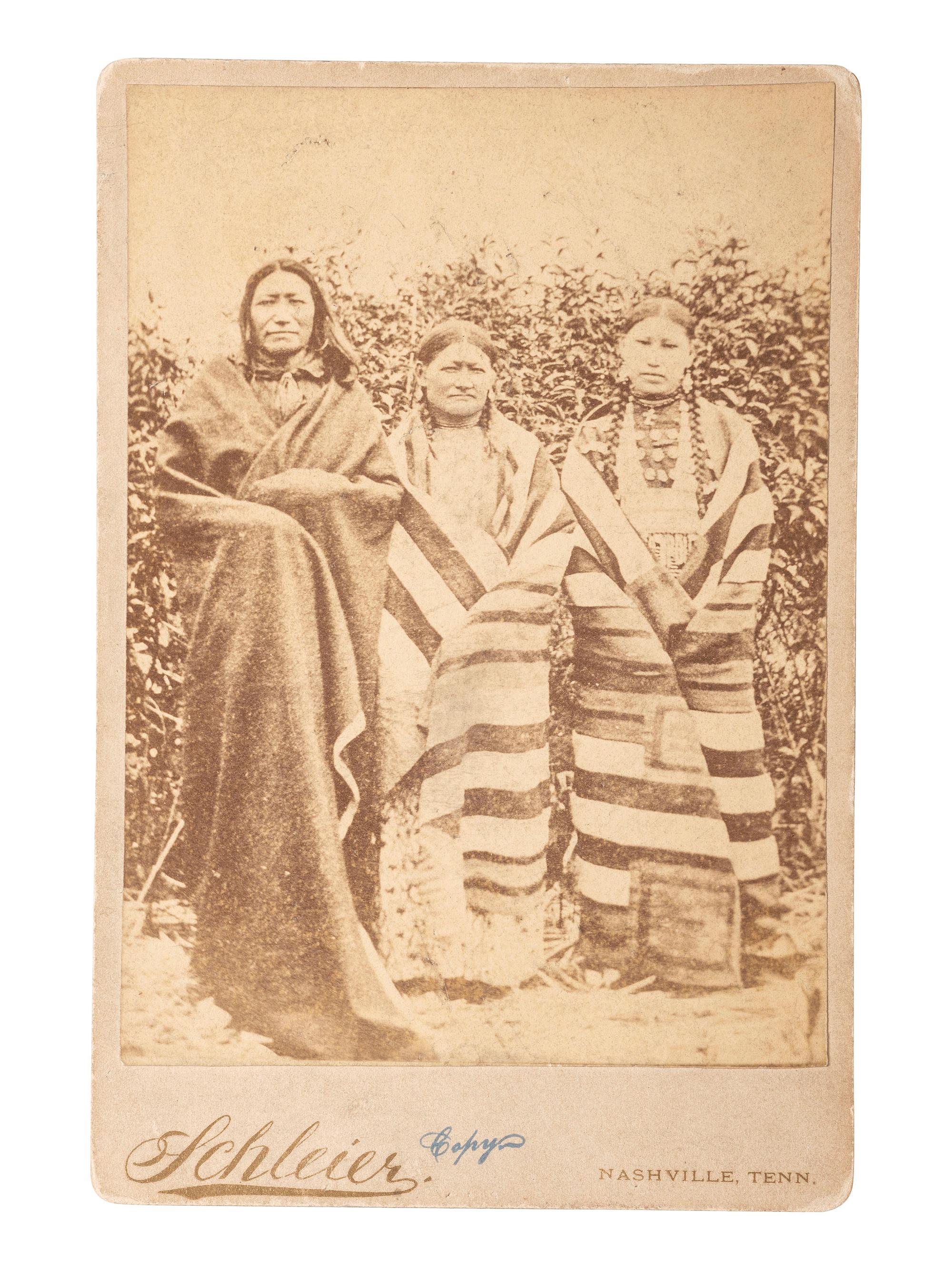 [NATIVE AMERICANS] -- [MORROW, Stanley J., photographer, after]. Period copy cabinet card of Brule Chief Spotted Tail with his wife and daughter. Nashville, TN: Schleier.