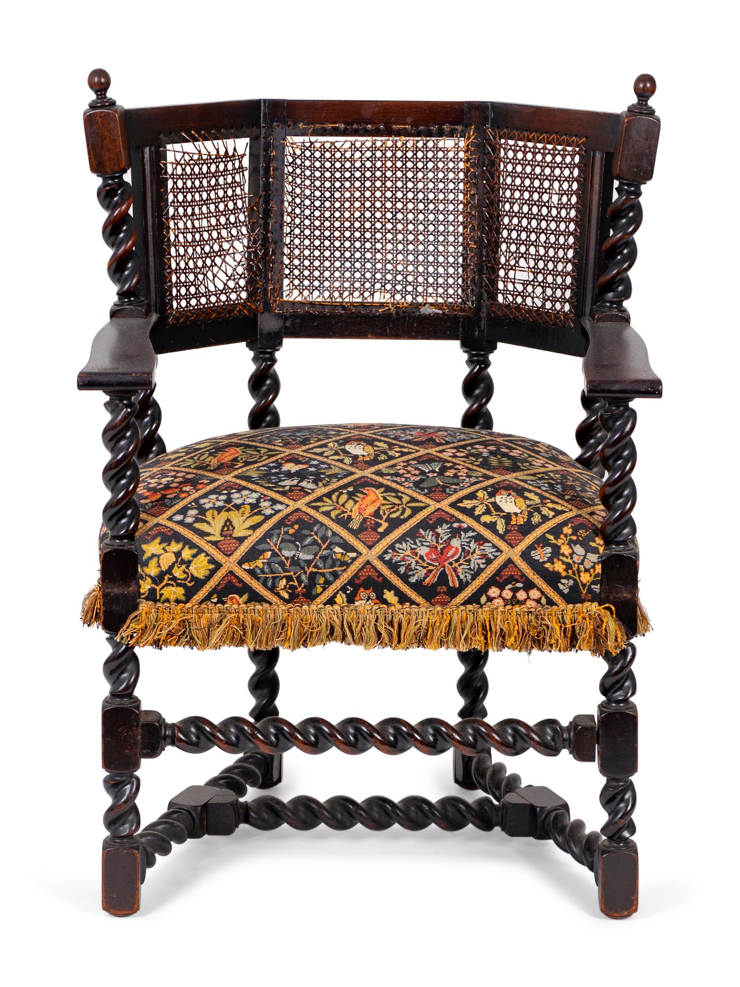 A Jacobean Style Carved Oak Cane Back Armchair — 19TH/20TH CENTURY