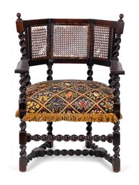 A Jacobean Style Carved Oak Cane Back Armchair — 19TH/20TH CENTURY