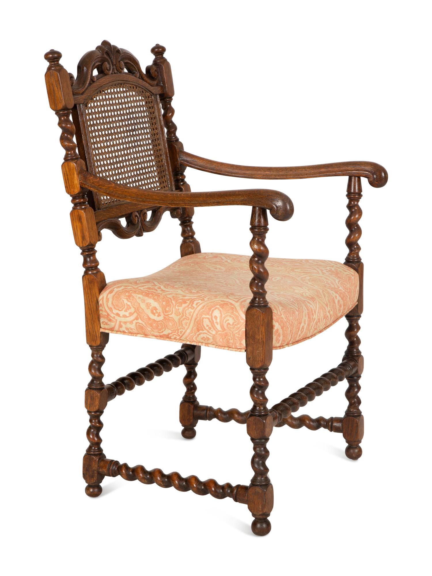A William and Mary Style Carved Oak Cane Back Armchair