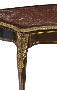 A Napoleon III Gilt Bronze Mounted Ebonized Marble-Top Center Table