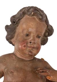 A Painted and Parcel Gilt Wood Figure of a Putto