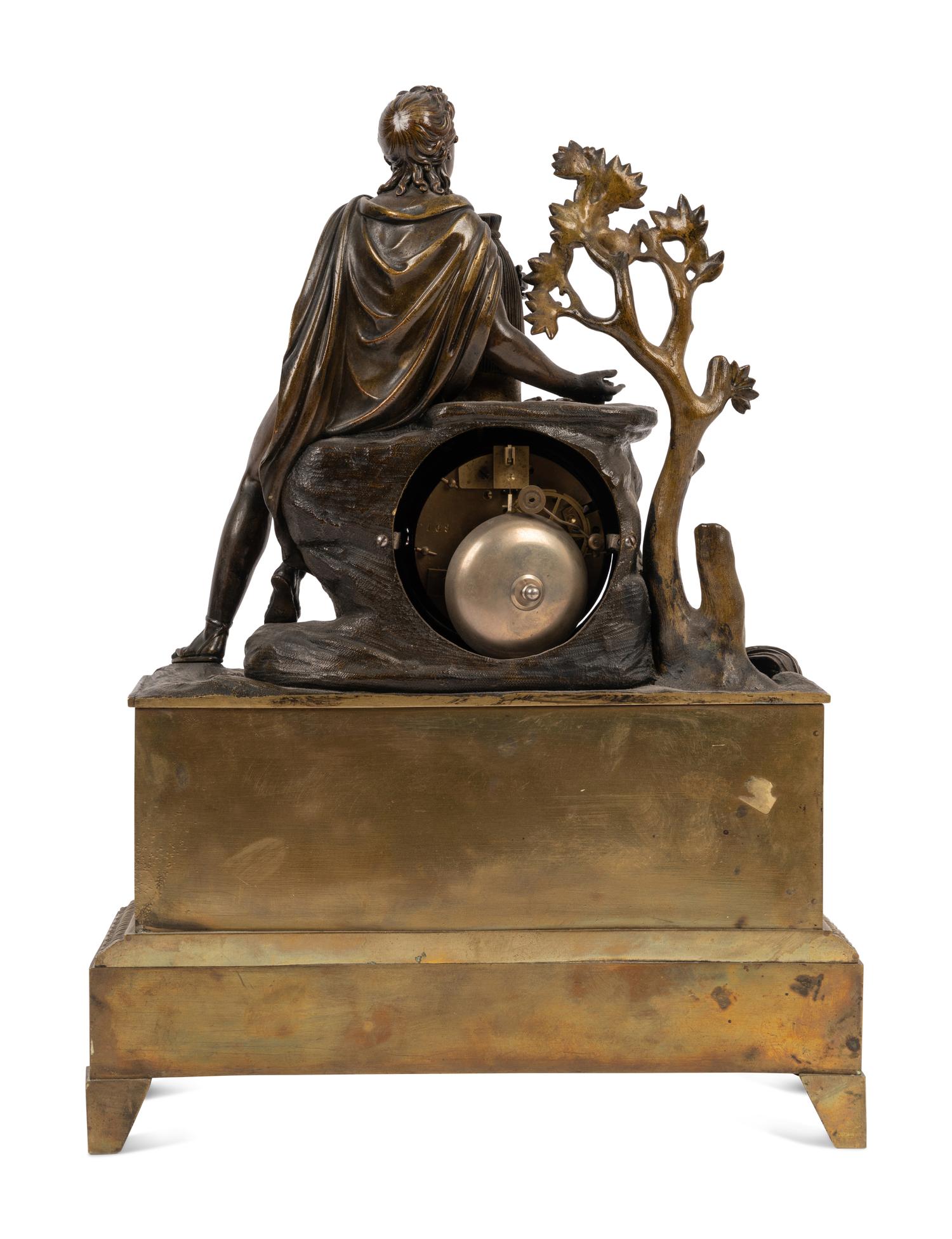 An Empire Style Gilt and Patinated Bronze Figural Mantel Clock