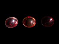 Three Chinese Red Peking Glass Snuff Dishes and A Plastic Imitating Amber Snuff Bottle