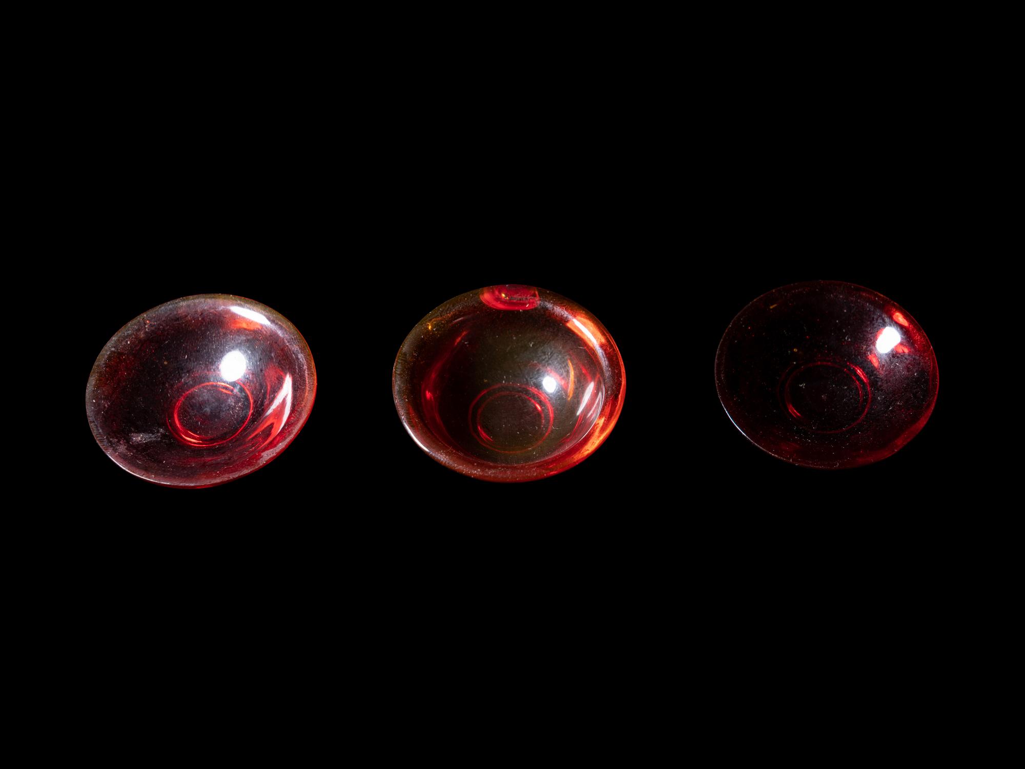 Three Chinese Red Peking Glass Snuff Dishes and A Plastic Imitating Amber Snuff Bottle