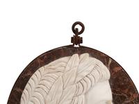 A Set of Four Italian Neoclassical Style Iron Mounted Marble Portrait Medallions