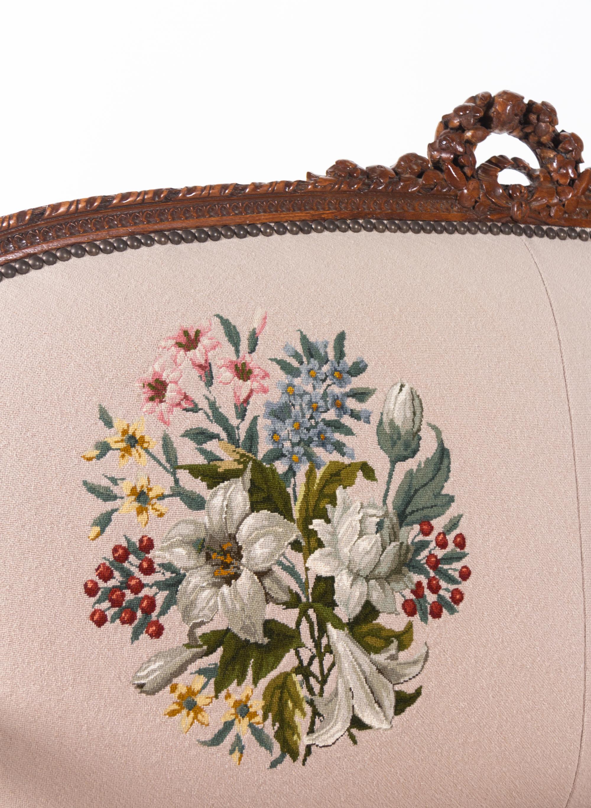 A Louis XVI Carved Walnut Seating Suite with Petit Point Upholstery
