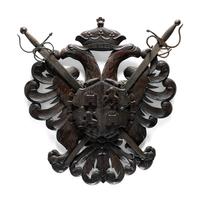 A Continental Carved Walnut Coat-of-Arms Plaque with Metal Crossed Swords