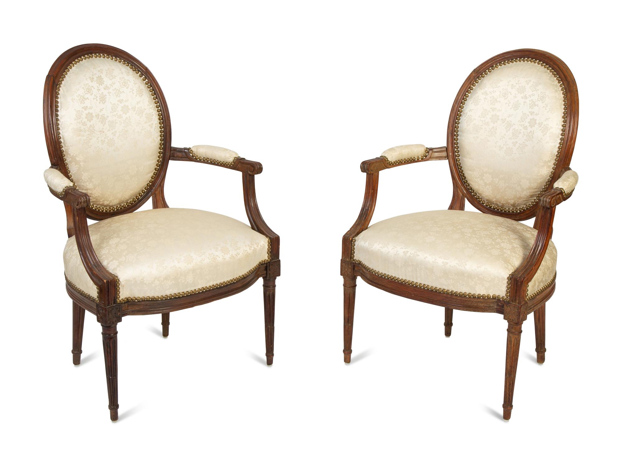 A Pair of Louis XVI Walnut Fauteuils en Cabriolet