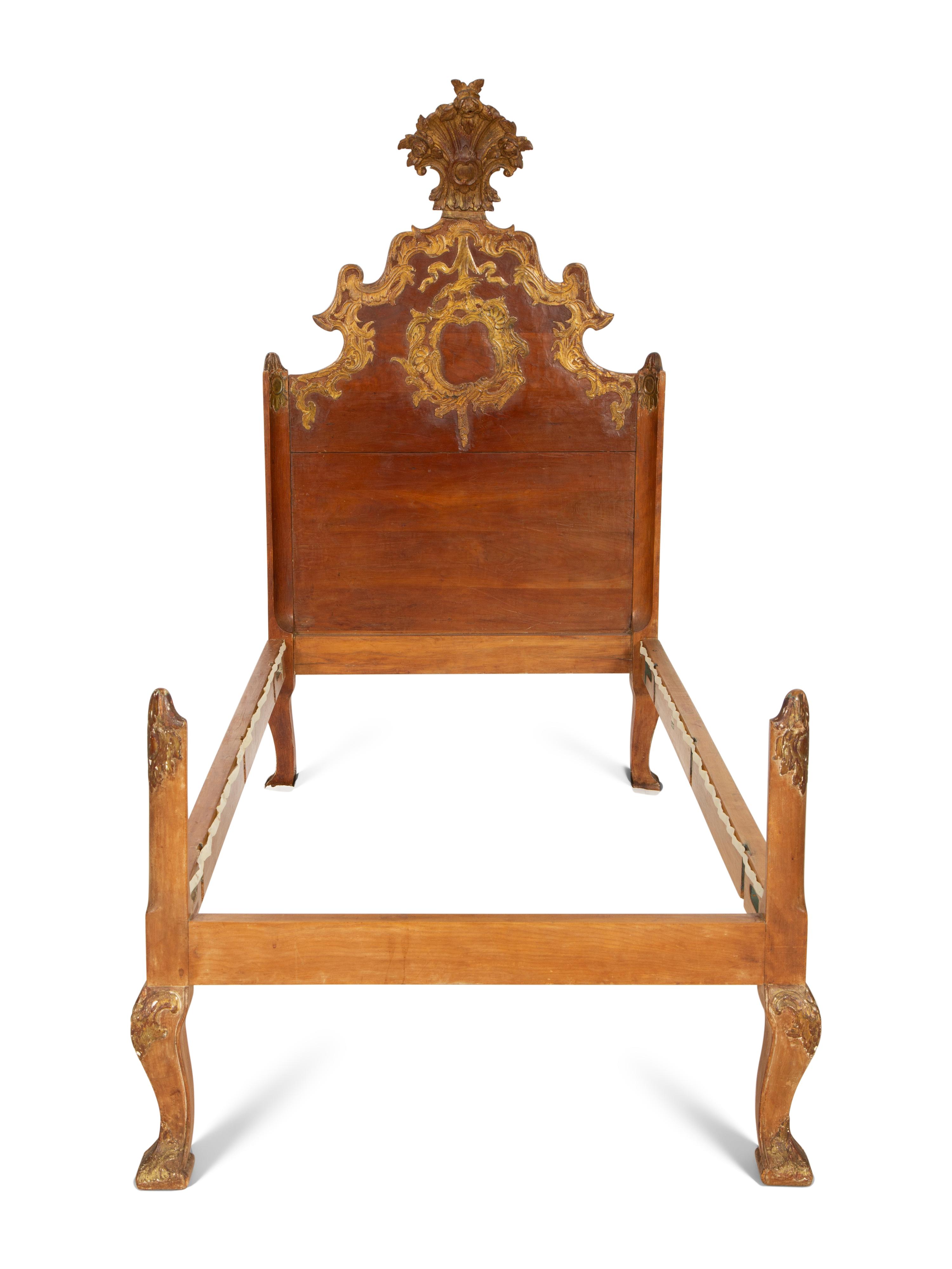 A Pair of Venetian Style Fruitwood and Parcel Gilt Twin Beds