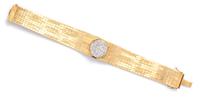 An 18 Karat Yellow Gold and Diamond Surprise Watch, 36.20 dwts.