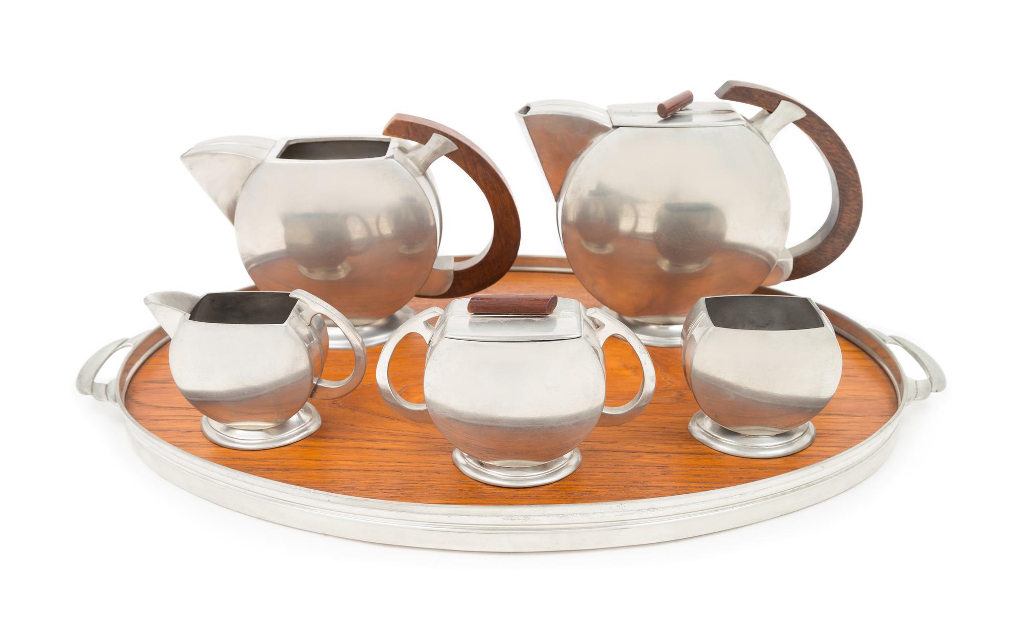 Art Deco, Holland, a tea and coffee service, comprising a tea pot, coffee pot, creamer, sugar, covered dish and tray
