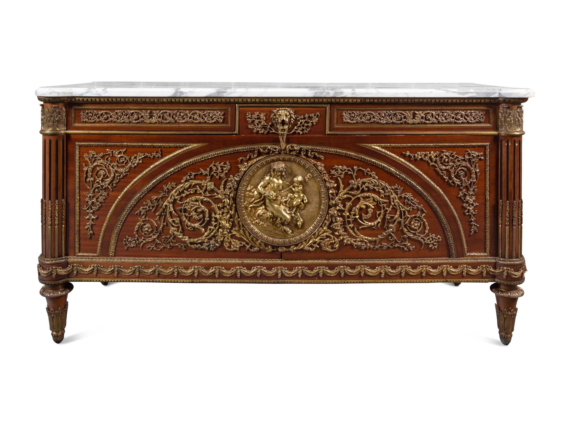 A Louis XVI Style Gilt Bronze Mounted Mahogany Marble-Top Commode à Vantaux, after the Model by Guillaume Benneman