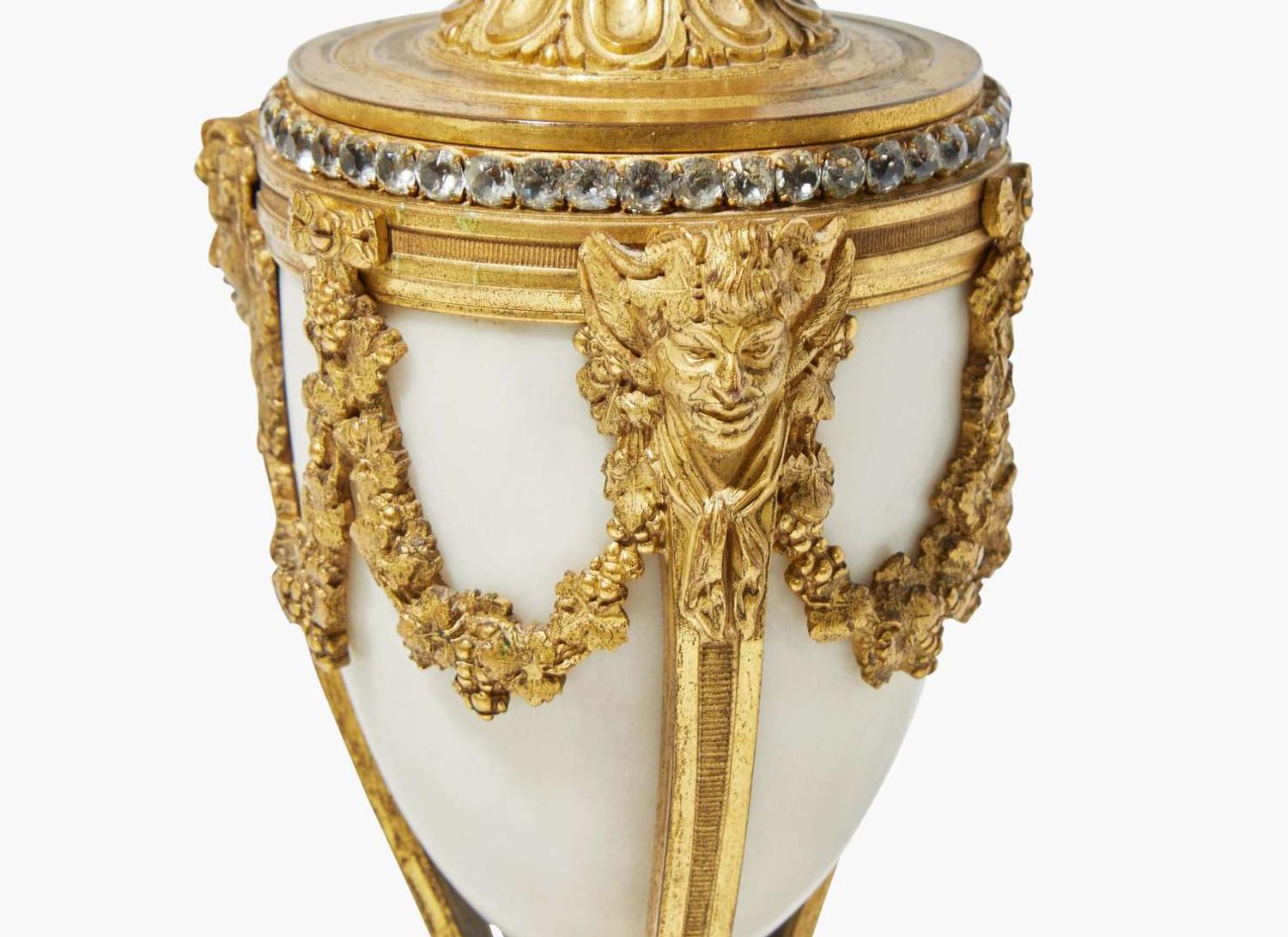 A French Louis XVI style three-piece gilt bronze and white marble clock garniture, retailed by Tiffany & Co., New York, NY, late 19th century