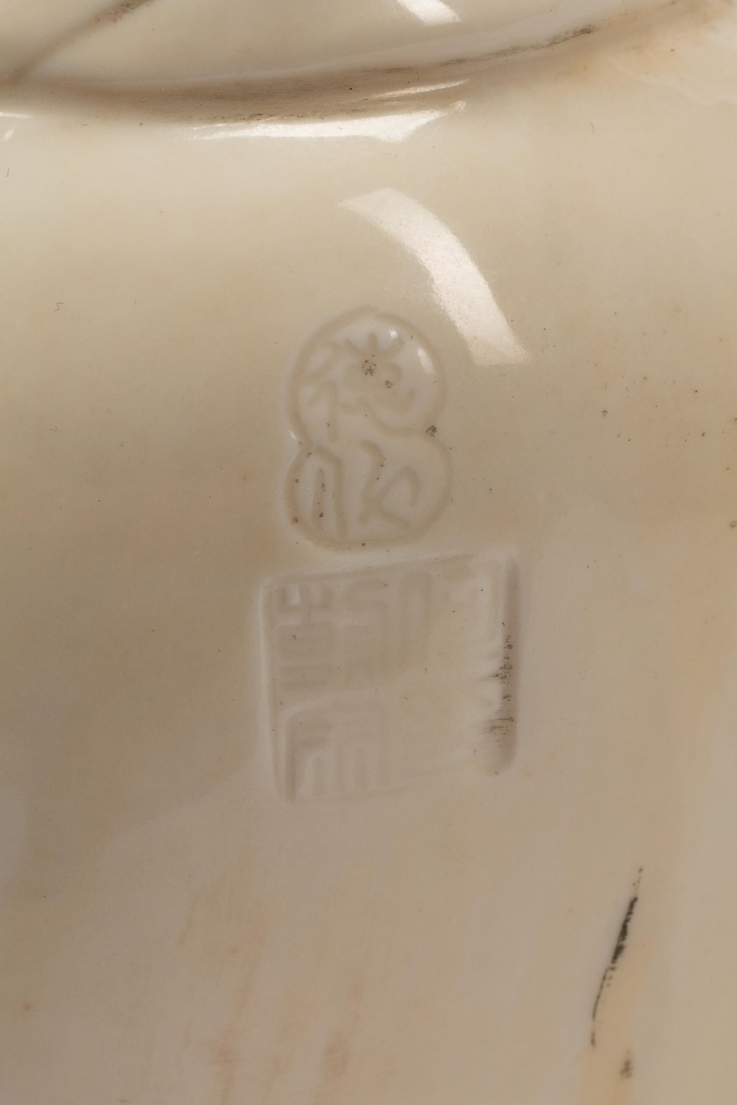 A Chinese Export White Glazed Porcelain Figure of a Seated Luohan