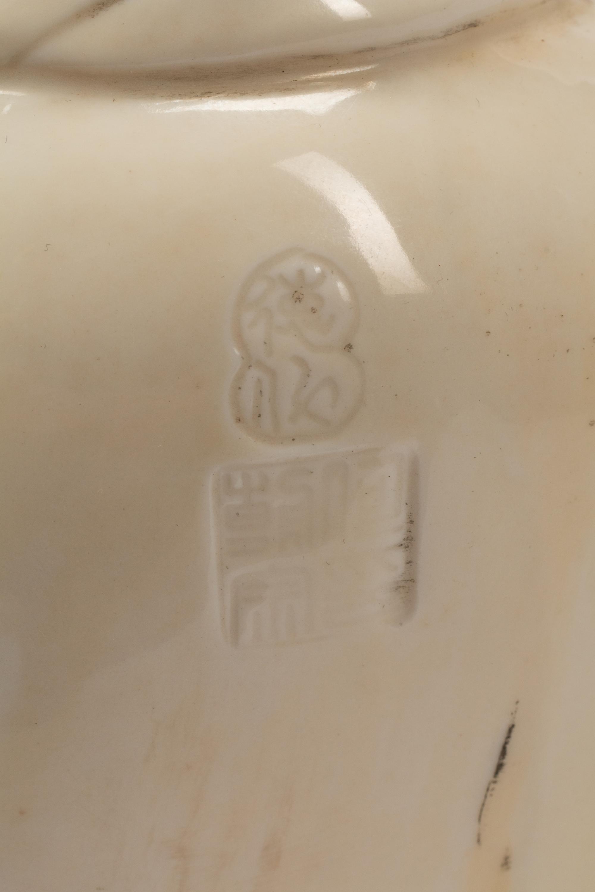 A Chinese Export White Glazed Porcelain Figure of a Seated Luohan