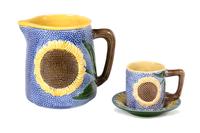 A Sunflower Majolica Pitcher and Cup with Saucer Height of pitcher 9 inches.