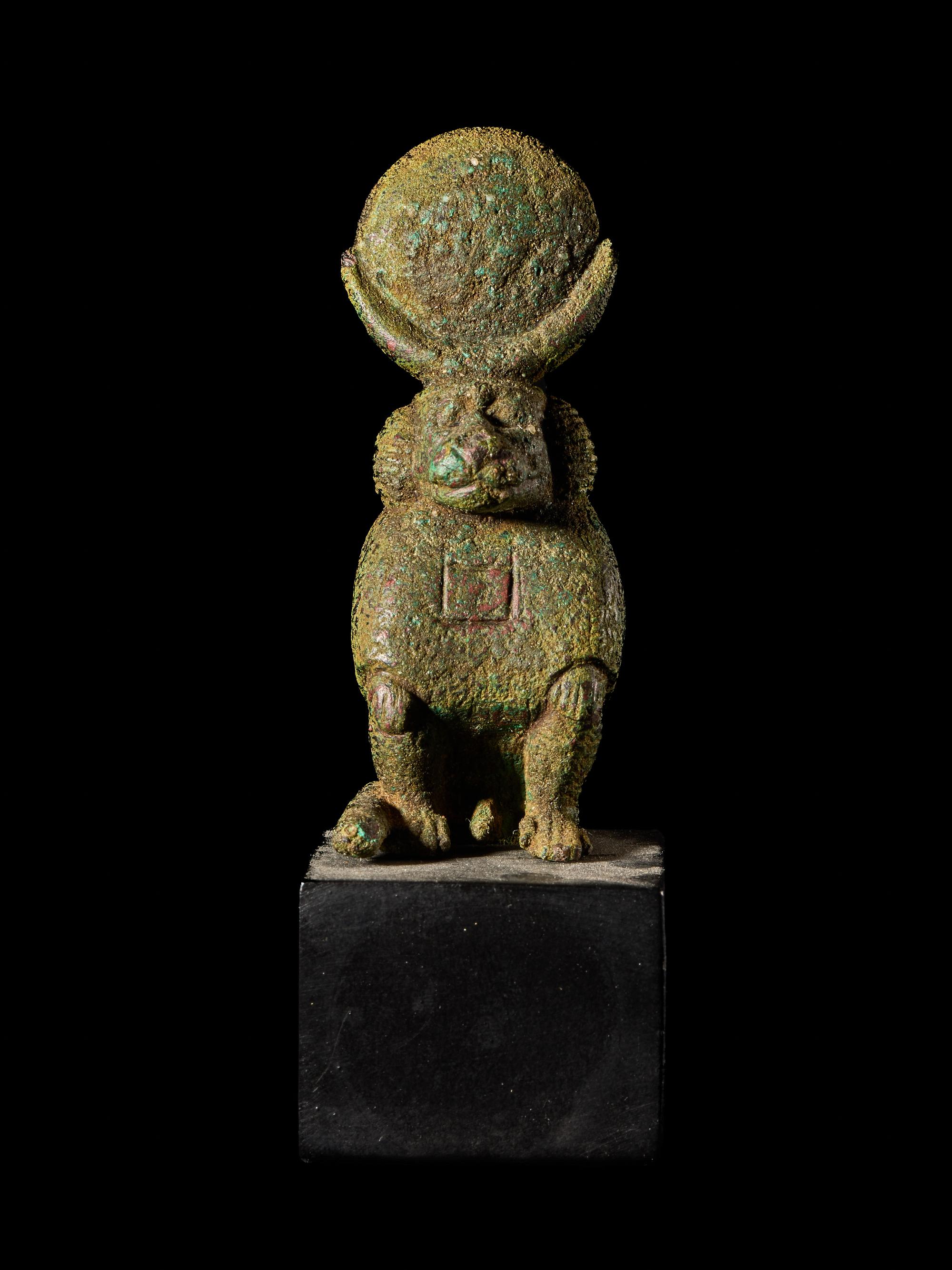 An Egyptian Bronze Baboon with a Sun Disc