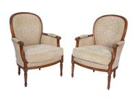 A Pair of Louis XVI Style Carved Walnut Bergères