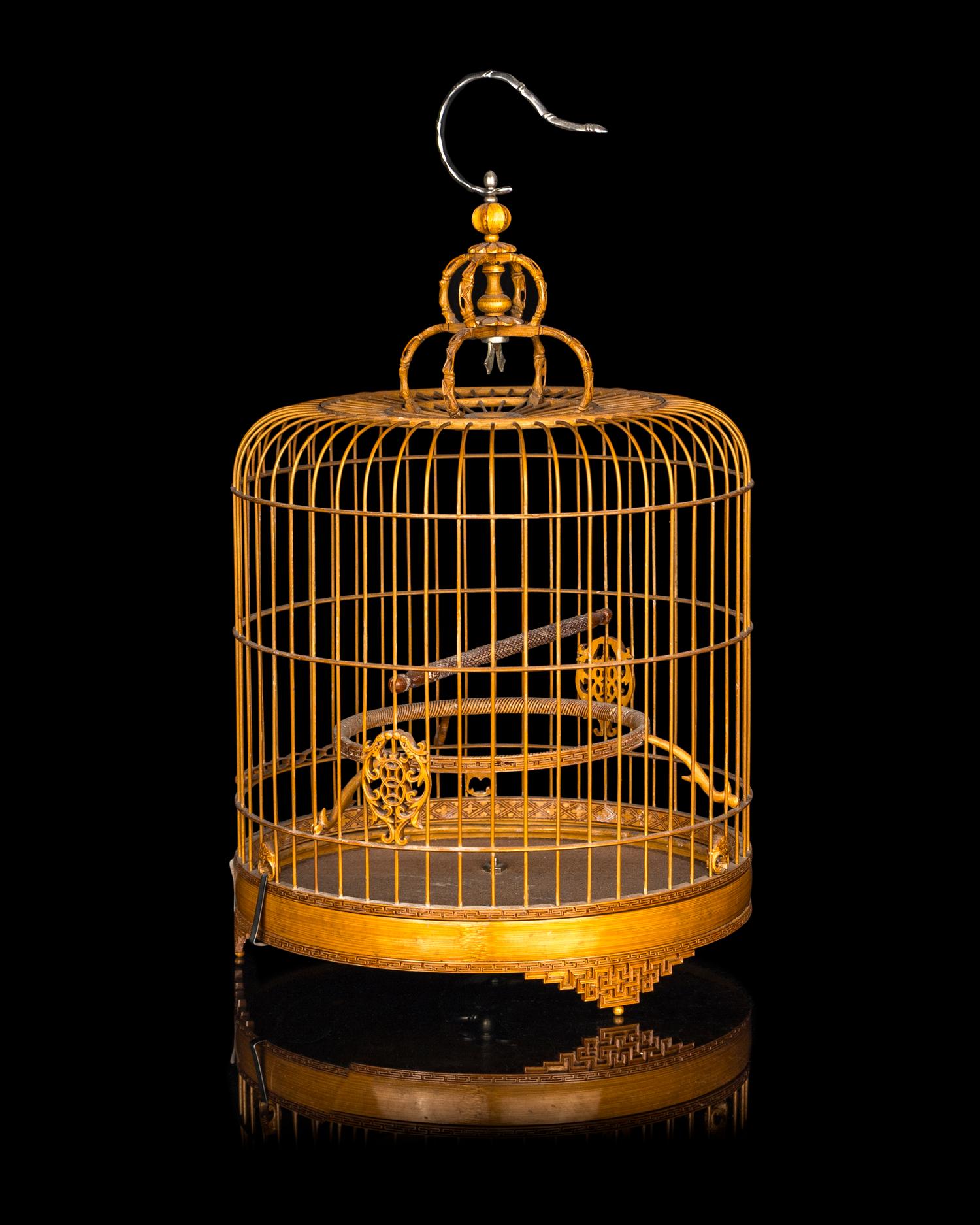 A Chinese Bamboo Bird Cage with A Pair of Wucai Porcelain Bird Feeders