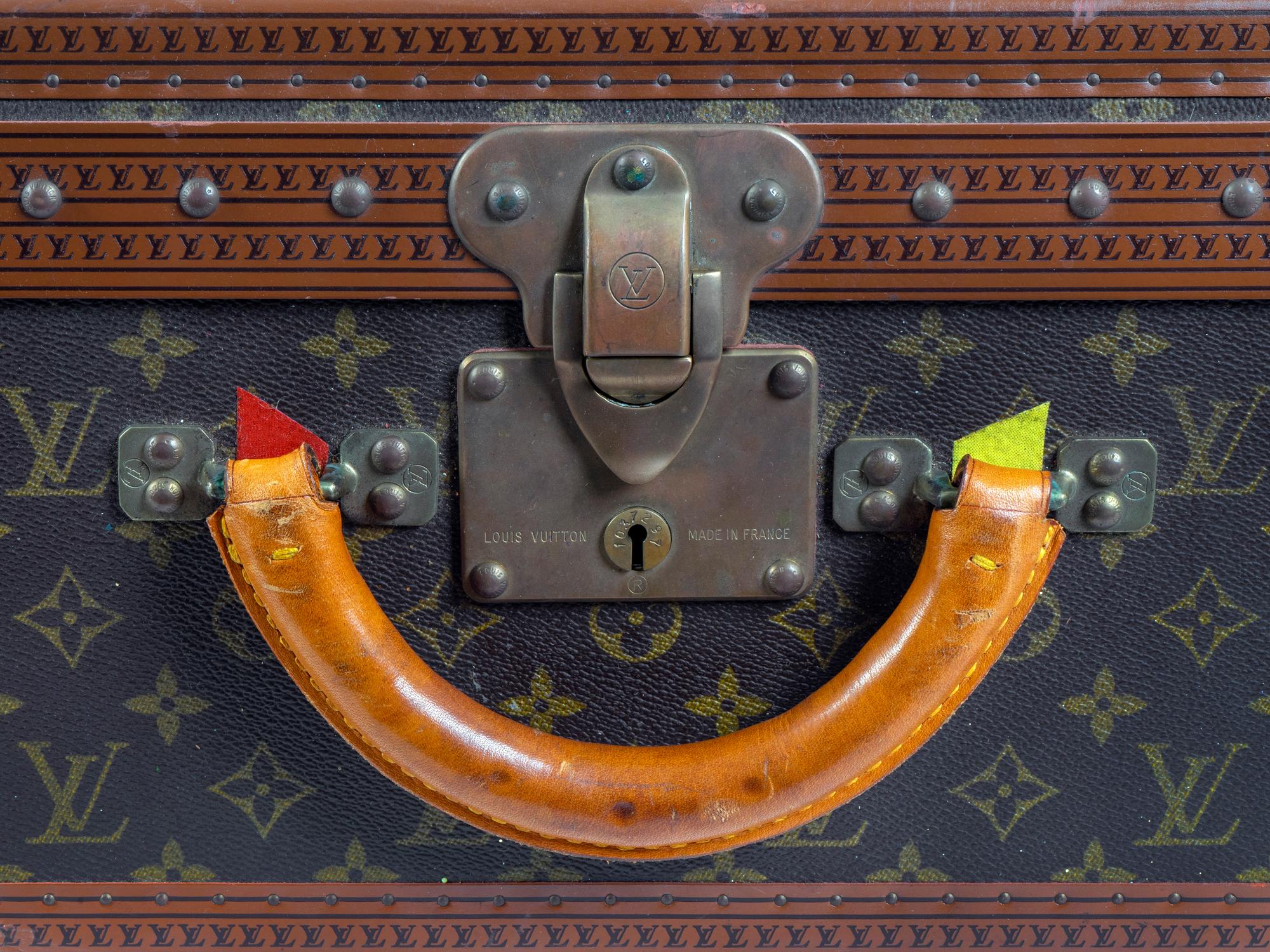 A Louis Vuitton Monogram Canvas Hardside Suitcase — 20TH CENTURY
