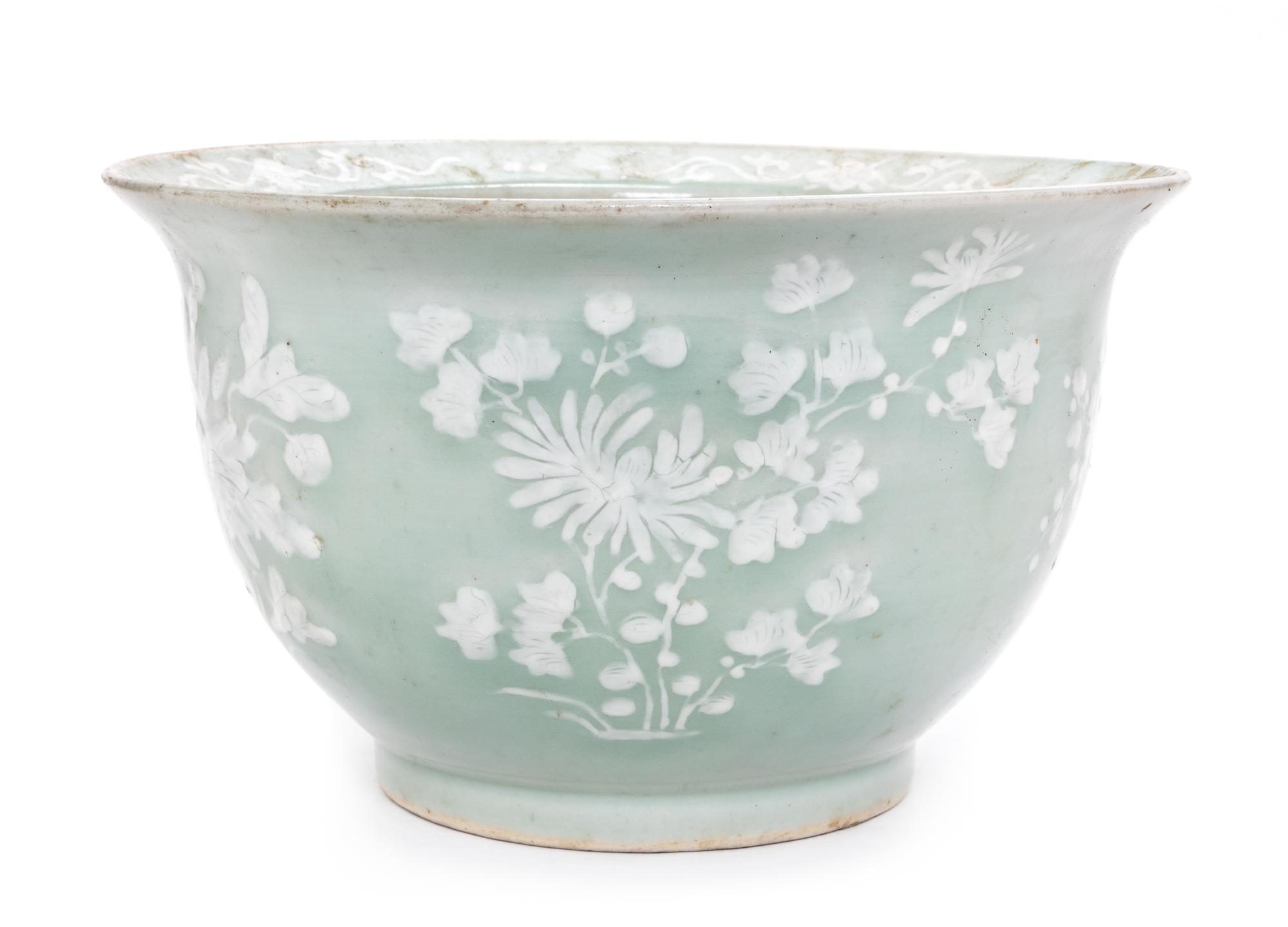 A Chinese White Slip Decorated Celadon Ground Cachepot Diameter 11 1/8 inches.