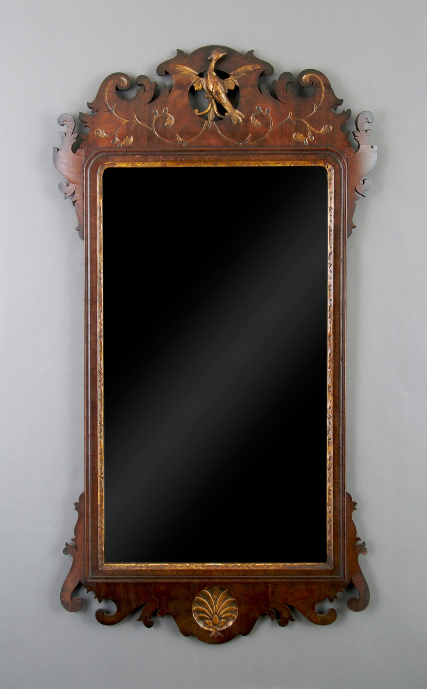 An American Mahogany and Parcel Gilt Chippendale Style Mirror, Height 42 x width 22 1/2 inches.