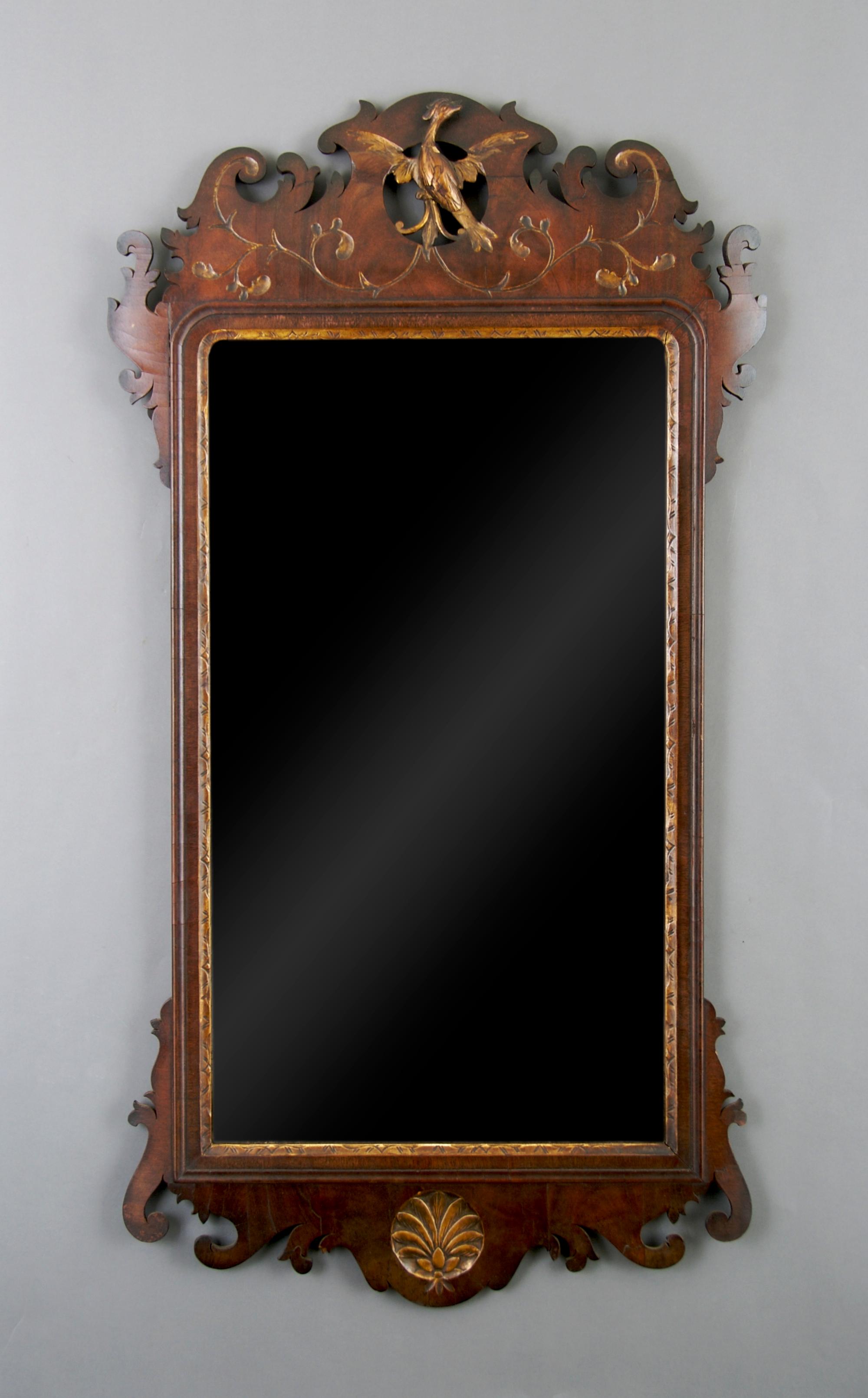 An American Mahogany and Parcel Gilt Chippendale Style Mirror, Height 42 x width 22 1/2 inches.