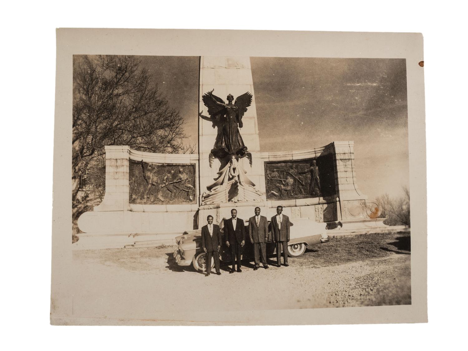 [CIVIL RIGHTS]. CRUMP, Johnnie R. (1905-1975), photographer. Photograph of African American men posed in front of Civil War monument. Vicksburg, MS: ca 1950s.