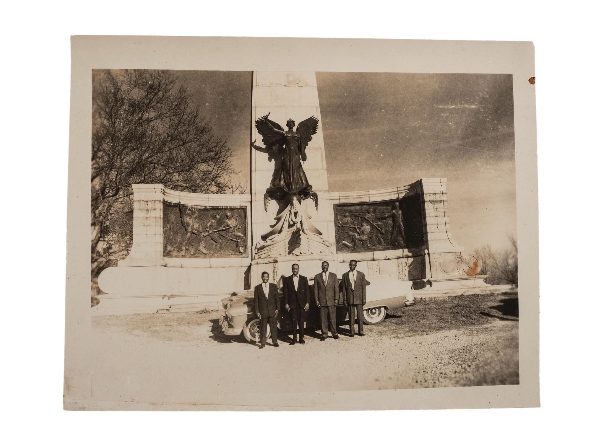 [CIVIL RIGHTS]. CRUMP, Johnnie R. (1905-1975), photographer. Photograph of African American men posed in front of Civil War monument. Vicksburg, MS: ca 1950s.