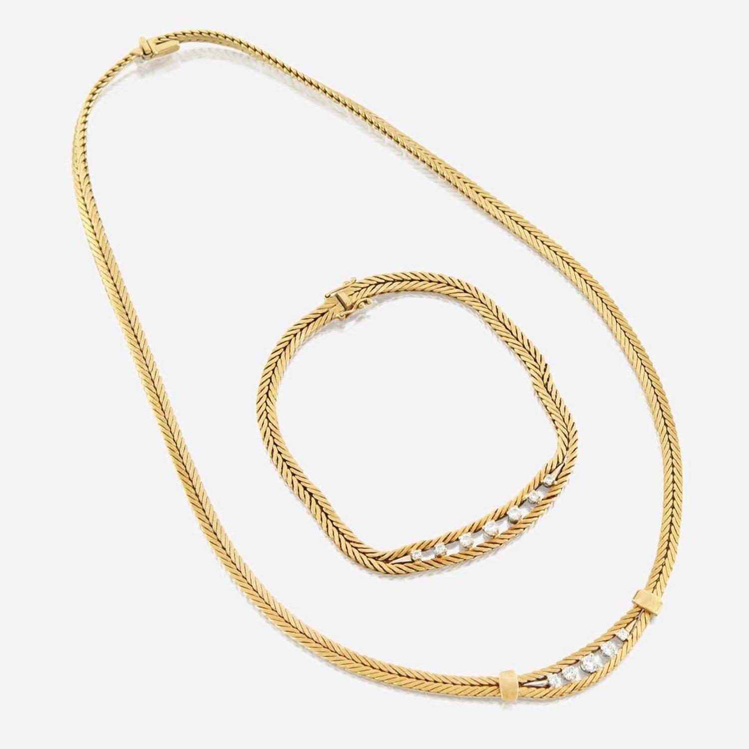 A gold and diamond necklace with matching bracelet Italy