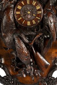 A Swiss Black Forest Carved Walnut Clock