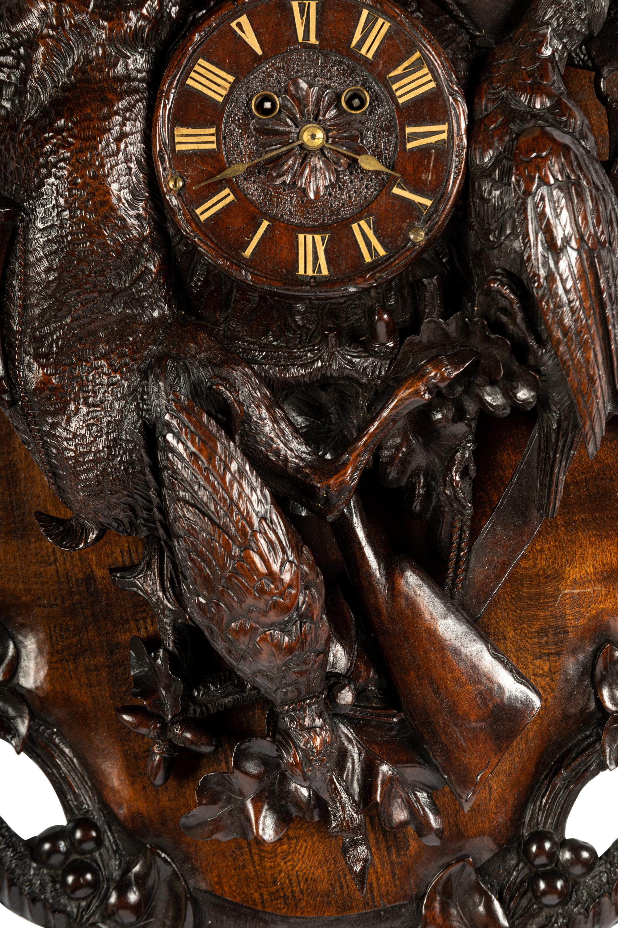 A Swiss Black Forest Carved Walnut Clock