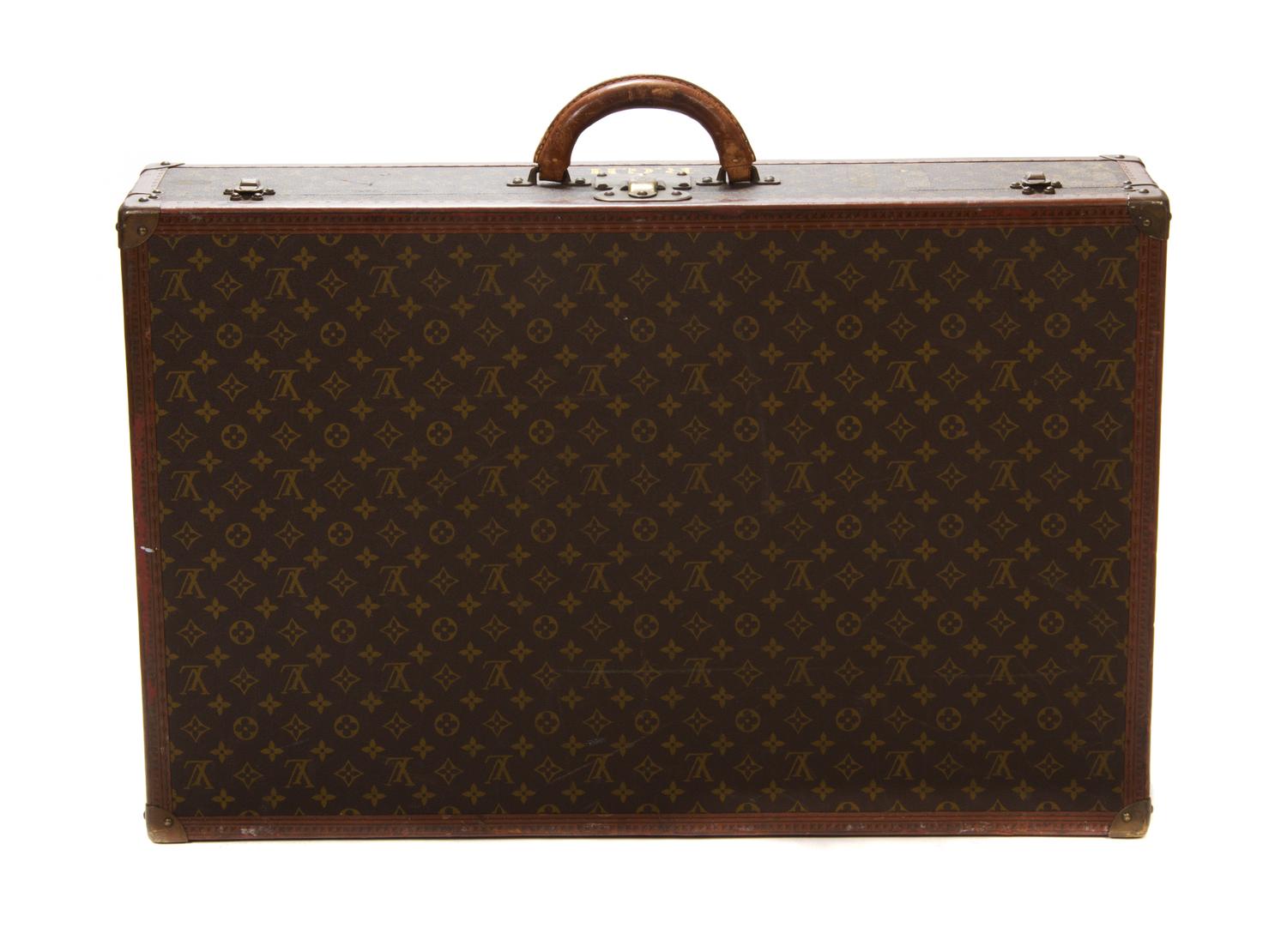 A Louis Vuitton Monogram Canvas Hard-sided Suitcase, 31 1/2 x 20 x 6 1/2 inches.