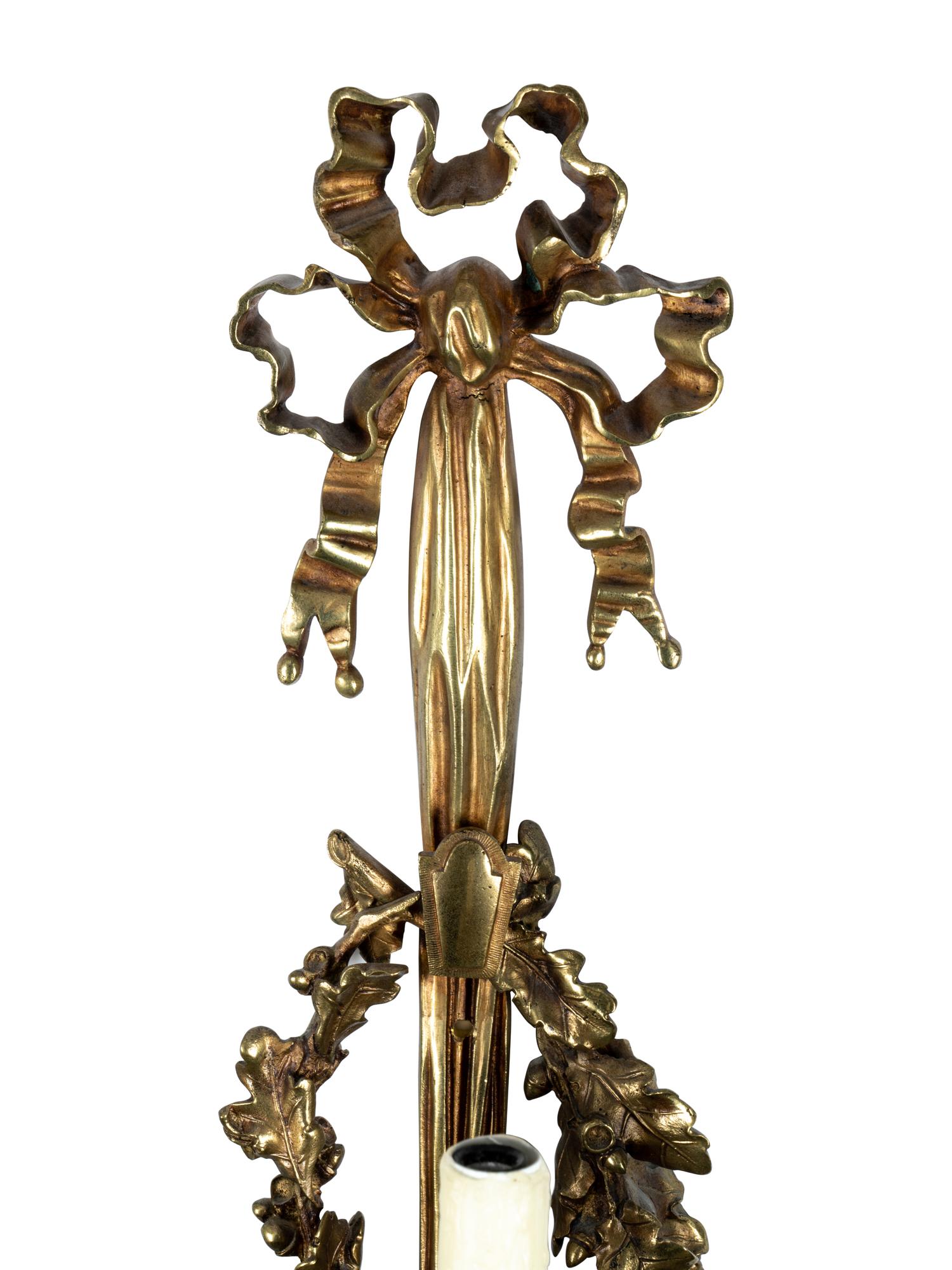 A Pair of Louis XVI Style Gilt Metal Three-Light Sconces