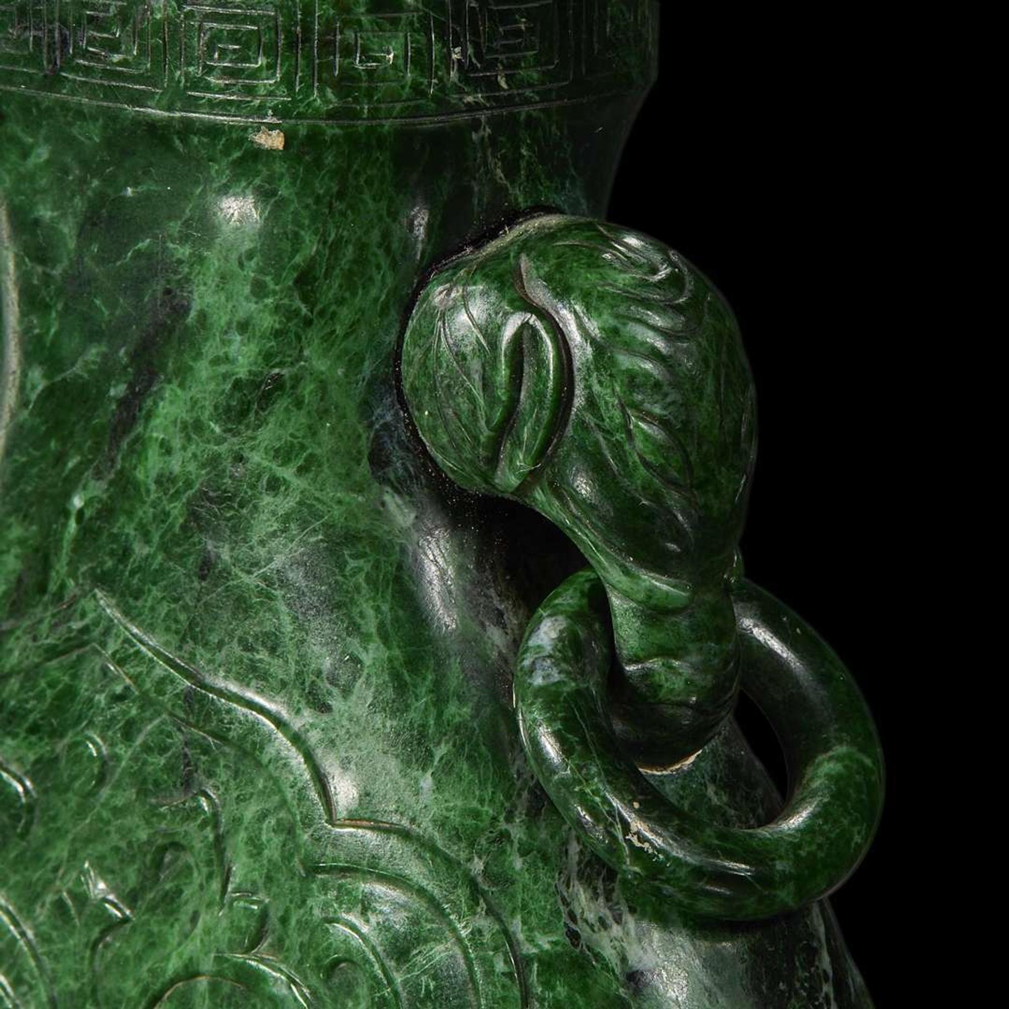 A Chinese carved chloromelanite vase and cover 玉盖罐
