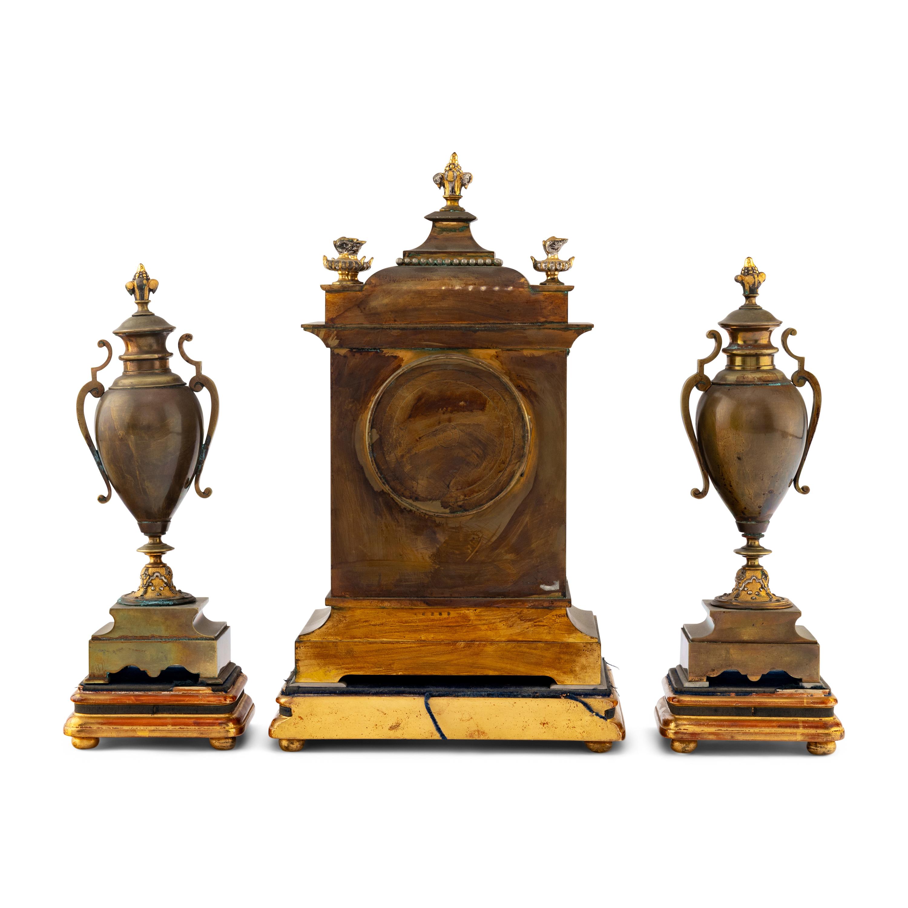 A French Brass and Mixed Metals Clock Garniture
