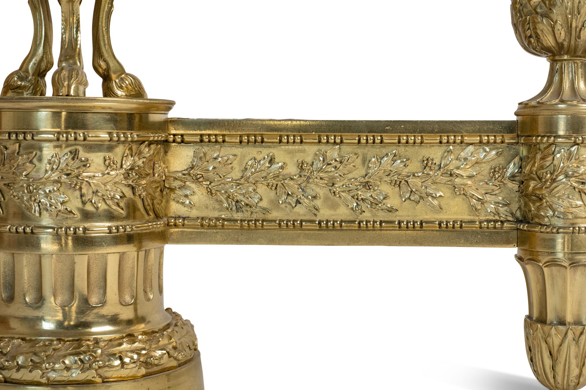 A Pair of Louis XVI Style Gilt Bronze Chenets with Flaming Urn Finials — 20TH CENTURY