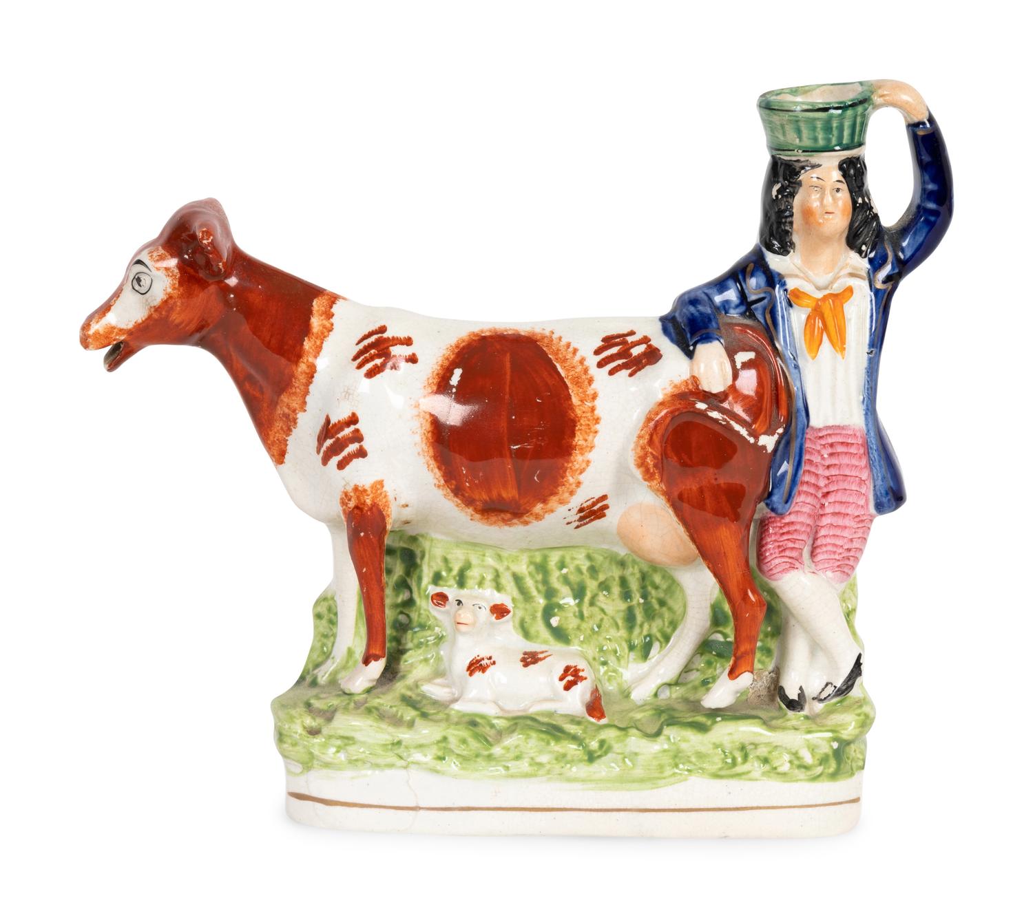 A Collection of Twelve Staffordshire Pottery Figures and Figural Wares