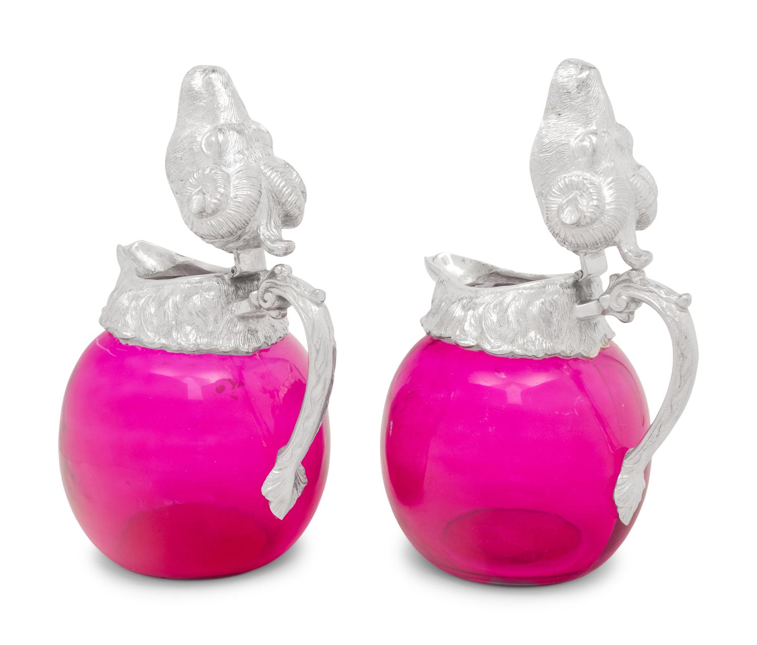 A Pair of Silver-Plate and Pink Glass Ram Decanters