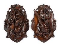 A Pair of Swiss Black Forest Carved Walnut Game Plaques