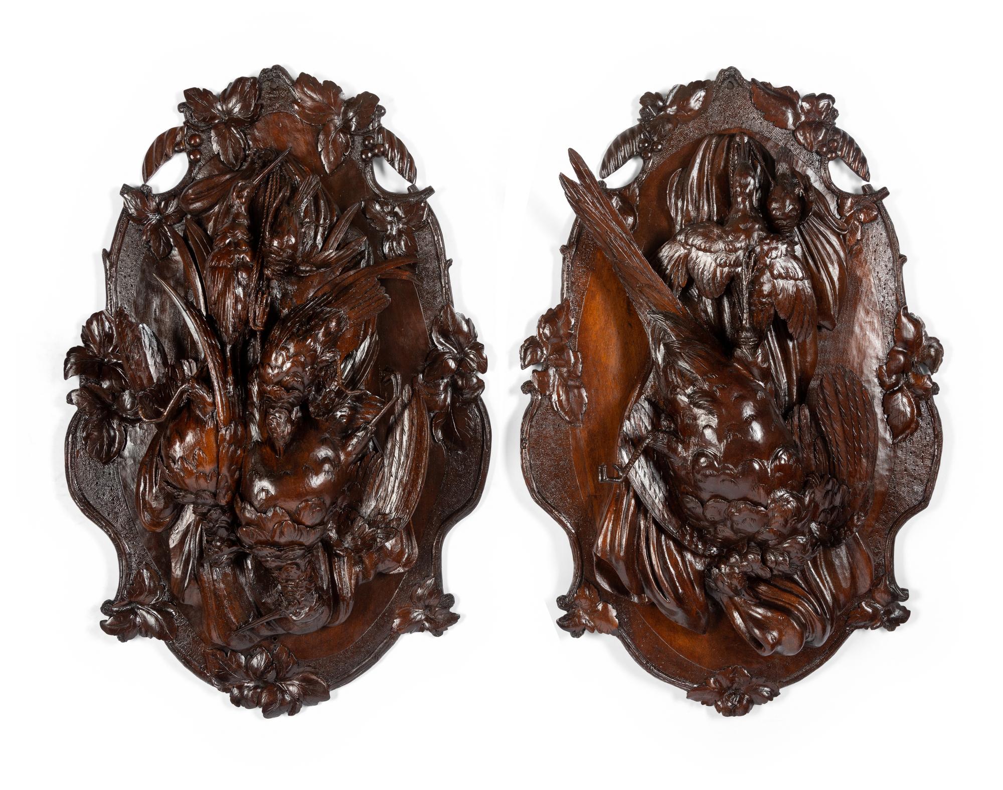 A Pair of Swiss Black Forest Carved Walnut Game Plaques
