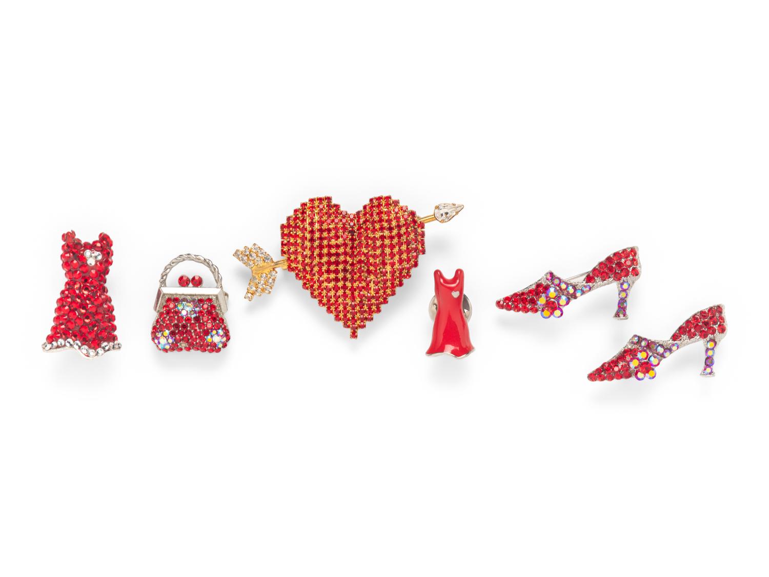 A COLLECTION OF RED BROOCHES
