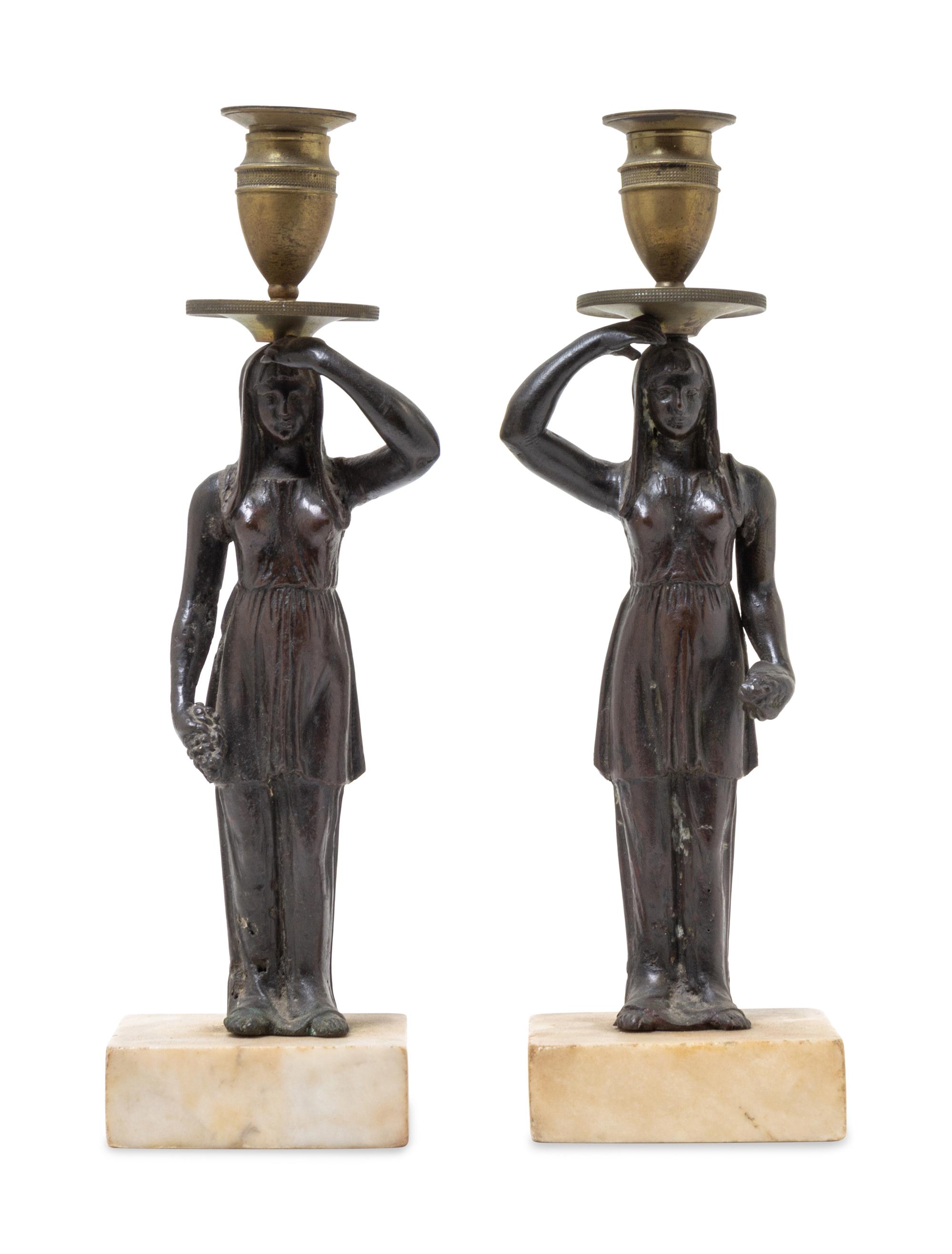 A Pair of Bronze Figural Candlesticks