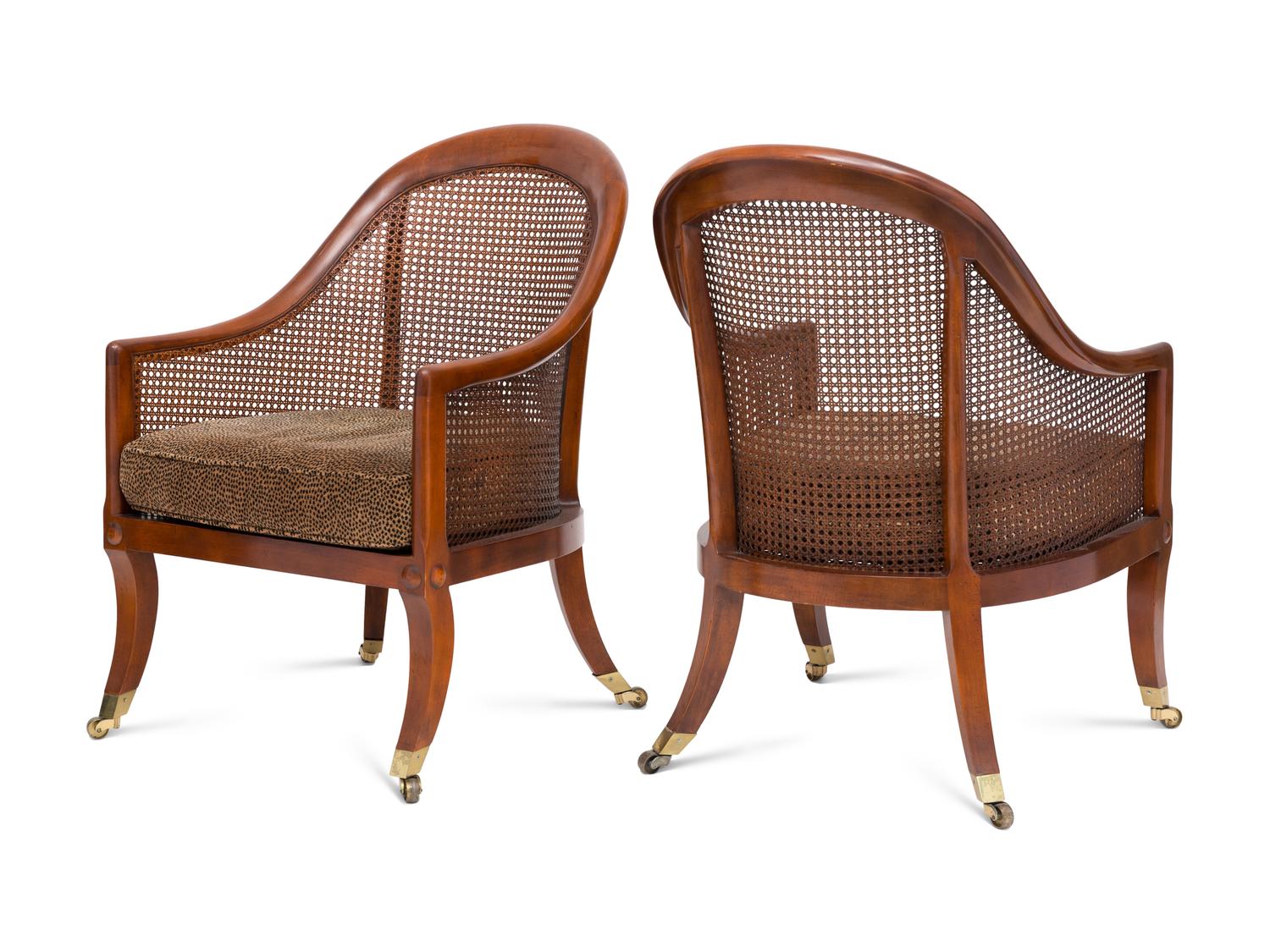 A Pair of Regency Style Walnut and Cane Barrel Chairs