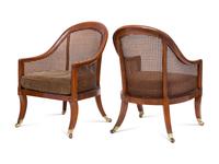 A Pair of Regency Style Walnut and Cane Barrel Chairs