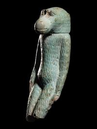An Egyptian Faience Standing Ape