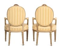 A Pair of Louis XVI Style Parcel Gilt and White Painted Fauteuils