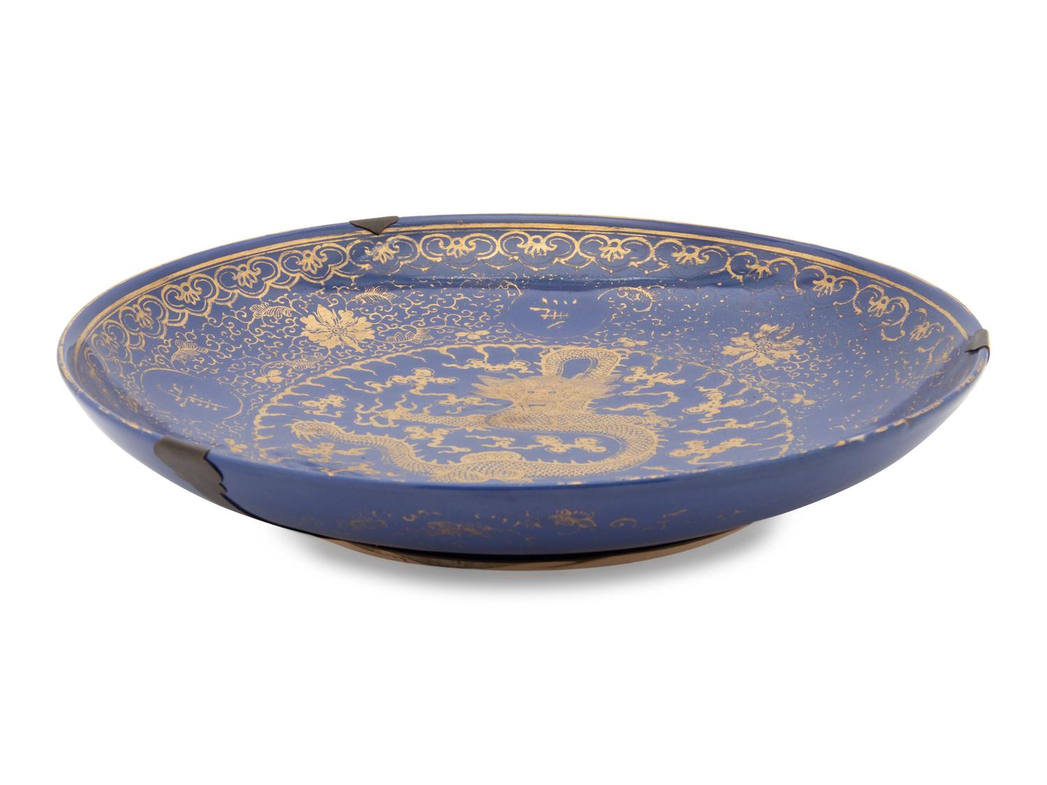A Large Gilt Decorated Powder Blue Glazed Porcelain Charger